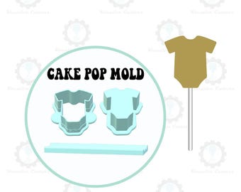 Könnte beinhalten: Ein hellblaues Cake-Pop-Formenset mit dem Text "CAKE POP MOLD" und einem goldfarbenen Babybody-Cake-Pop. Das Set enthält zwei Babybody-förmige Formen und eine rechteckige Form. Der Cake Pop befindet sich auf einem silbernen Stiel.