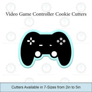 Può includere: Un tagliabiscotti nero a forma di controller per videogiochi con un contorno azzurro. Il controller ha pulsanti e tastierini direzionali bianchi. Il testo in alto recita "Video Game Controller Cookie Cutters". Il testo in basso recita "Cutters Available in 7-Sizes from 5cm to 13cm".