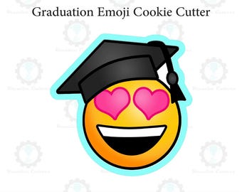 May include: A graduation emoji cookie cutter. The emoji has a yellow face with pink heart eyes and a wide, happy smile. It is wearing a black graduation cap. The text "Graduation Emoji Cookie Cutter" is above the emoji.