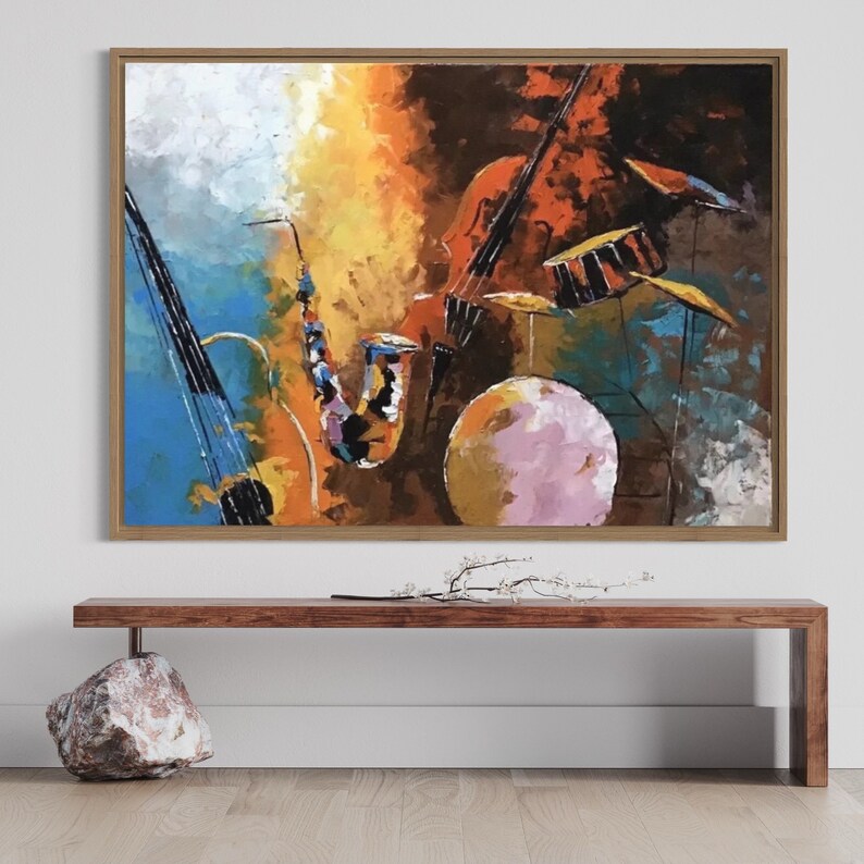 Colorful abstract painting of jazz instruments including a saxophone, upright bass, and drum set with bold, expressive brushstrokes and vibrant tones.May include: A painting of a musical band with a saxophone, a violin, and a drum set. The painting is done in a colorful abstract style with shades of blue, yellow, orange, red, and brown. The painting is framed in a light brown frame.
