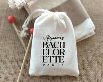 May include: White cotton drawstring bag with black text that reads "Alejandra's Bachelorette Party".