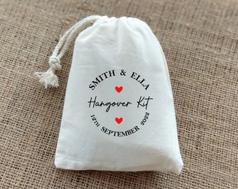 May include: White cotton drawstring bag with a black and red circle design that says "Smith & Ella Hangover Kit 12th September 2022".