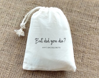 May include: White drawstring bag with the text "But did you die? Amy's Bachelorette" printed on it.