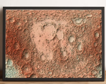 May include: A framed print of a close-up of a cratered surface, resembling the moon, with a mix of orange, red, and green hues.