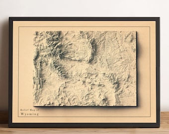 May include: A framed relief map of Wyoming with a beige background and black frame. The map shows the state's topography with brown and green hues. The text "Relief Map of Wyoming" is printed in black at the bottom of the map.