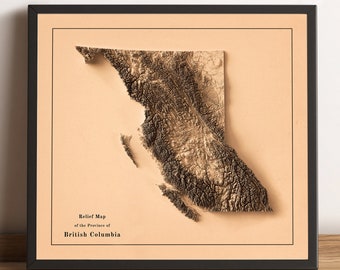 May include: A framed relief map of the province of British Columbia. The map is in shades of brown and beige, with a raised texture to show the topography of the region. The title "Relief Map of the Province of British Columbia" is printed below the map.