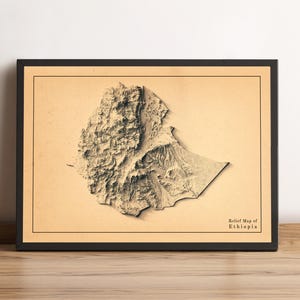Puede incluir: Un mapa en relieve enmarcado de Etiopía, que muestra la topografía del país en tonos marrones y beige. El mapa está sobre un fondo marrón claro con el texto "Relief Map of Ethiopia" en la esquina inferior derecha.
