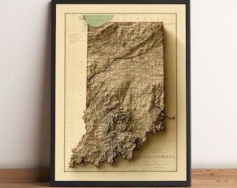 May include: A vintage, framed map of the State of Indiana with a 3D relief effect. The map is in shades of brown and green, with black lines indicating rivers and roads. The title "STATE of INDIANA" is printed in red at the bottom of the map.