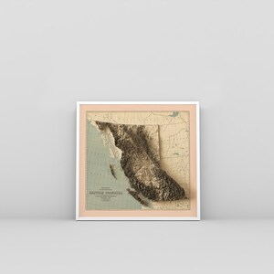 British Columbia vintage framed shaded relief map in white frame. Artistic print highlighting mountains with a realistic 3d effect