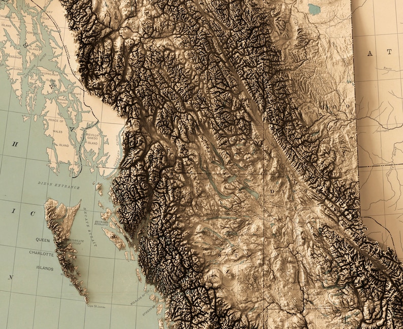 Detailed close-up of a vintage British Columbia relief map, showcasing textured topography and geographic contours