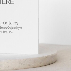 May include: A white card with the text "File contains" followed by "PSD with Smart Object layer + Hi-Res JPG" on a white textured surface.