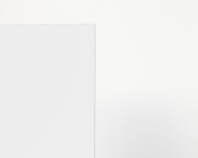May include: A plain white sheet of paper with a slightly textured surface.