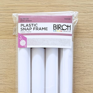 May include: A pack of 12 white plastic snap frame pieces, 27.9 cm by 27.9 cm, for making a picture frame. The pack is labelled "Plastic Snap Frame" and "Birch Creative".