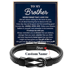 May include: A black braided leather bracelet with a stainless steel infinity symbol clasp. The bracelet is personalized with the name "Ethan". A card with the text "To My Brother" and a heartfelt message is included.