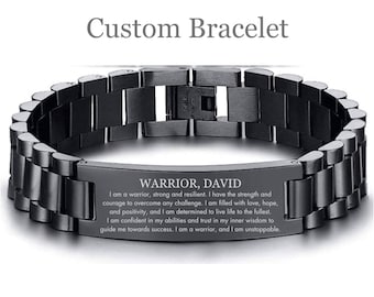 May include: Black stainless steel bracelet with a black engraved plate that reads "WARRIOR, DAVID" and a motivational message about strength, resilience, and inner wisdom.