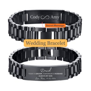 May include: Black stainless steel wedding bracelet with engraved text. The top bracelet reads "Cody ∞ Amy" and the bottom bracelet reads "David" with a message and date. The bracelet has a link design and a clasp closure.
