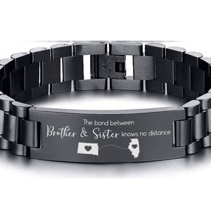 May include: Black stainless steel bracelet with a silver inscription that reads "The bond between Brother & Sister knows no distance". The inscription also includes two small heart-shaped outlines of the states of Iowa and Illinois.