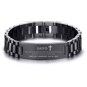 May include: Black stainless steel bracelet with a silver inscription that reads "DAIVD + MAY THE LORD GIVE HIS ANGELS CHANGE OVER YOU, TO GUIDE YOU IN ALL YOUR WAYS. FIRST HOLY COMMUNION - MAY 24, 2023".