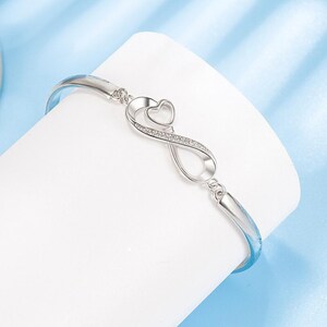 a silver bracelet with a heart on it