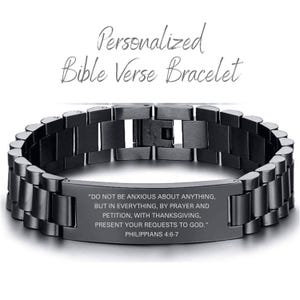 May include: A black stainless steel bracelet with a silver plaque engraved with the Bible verse Philippians 4:6-7. The verse reads "Do not be anxious about anything, but in everything, by prayer and petition, with thanksgiving, present your requests to God."