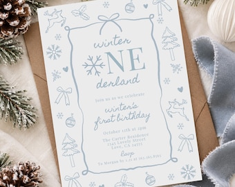 May include: A white rectangular invitation card with light blue text and illustrations. The text reads winter ONE derland, winter's first birthday, October 12th at 2pm, The Carter Residence, 2345 Lovely Street, Love, CA 24555, RSVP to Morgan by 1.21 at 563.365.8365.