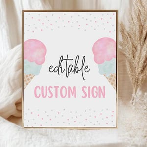 May include: A framed sign with a gold border features two watercolour ice cream cones with pink and blue scoops. The words "editable CUSTOM SIGN" are displayed in black and pink, with a scattering of pink and blue dots.