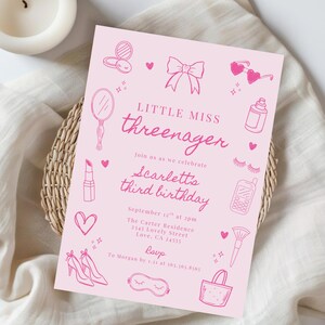 May include: A light pink rectangular birthday invitation card featuring dark pink line art illustrations of a bow, heart-shaped sunglasses, lipstick, a hand mirror, a makeup brush, high heels, and a phone with the text Little Miss Threenager.