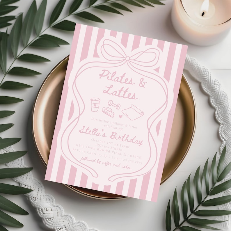 May include: A pink and white striped invitation card with the text "Pilates & Lattes" and "Stella's Birthday". The card features a bow and line art illustrations of a coffee cup, dumbbell, yoga mat, and other fitness-related icons. The invitation is on a gold plate.