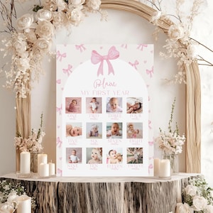 May include: A personalized baby milestone poster with the name "Blaire" and the text "MY FIRST YEAR". The poster features a pink bow and small bows scattered across a white background. It includes spaces for photos from one to twelve months.
