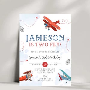 May include: A blue and red aeroplane themed birthday invitation for a boy's second birthday party. The invitation features a red aeroplane with blue accents and the text "Jameson is Two Fly!"  The invitation also includes the date and time of the party, the address, and the RSVP information.