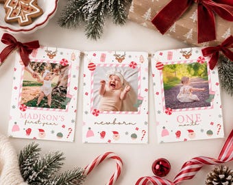 May include: Three rectangular photo cards featuring a Christmas theme with pink and red holiday icons like ornaments, mittens, and candy canes. The cards display baby photos and text reading MADISON'S first year, newborn, and ONE month.