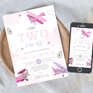 May include: A pink and purple airplane-themed birthday invitation and a smartphone displaying the same design. The invitation reads "TIME TWO take off!" and includes details for Chloe's 2nd birthday, with airplane illustrations and compass graphics.