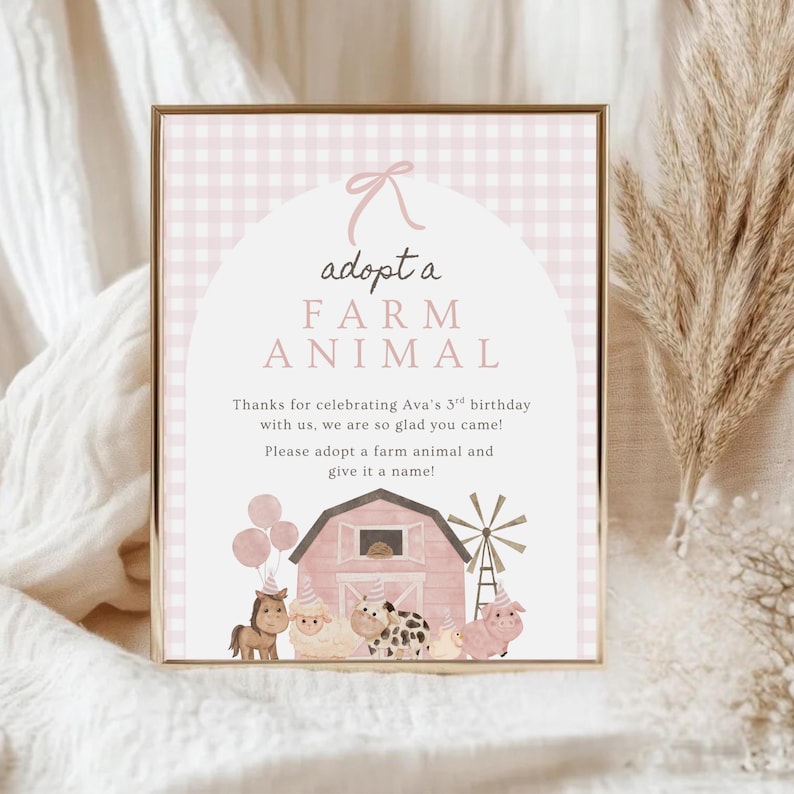 May include: A framed sign with a pink and gold theme, featuring the text "adopt a FARM ANIMAL." The sign includes illustrations of farm animals, a barn, and a windmill. The text reads, "Thanks for celebrating Ava's 3rd birthday with us..."