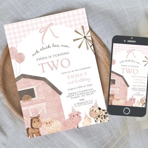 May include: A pink and white invitation and a smartphone showing the same design. The invitation says "Emma is turning two" with farm animal illustrations. The design includes a barn, windmill, and balloons.