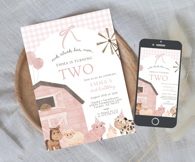 May include: A pink and white invitation and a smartphone showing the same design. The invitation says "Emma is turning two" with farm animal illustrations. The design includes a barn, windmill, and balloons.