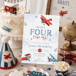 May include: A birthday party scene with a cake, invitation, and decorations featuring a vintage airplane theme. The invitation reads "Ready Four Take Off!" with the date and time of the party. Red and blue are the dominant colors.