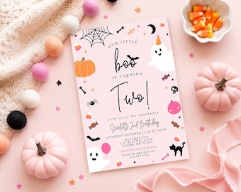 May include: A rectangular light pink birthday invitation card featuring Halloween-themed illustrations including a ghost, pumpkin, spider web, bat, and candy. The text reads: Our little boo is turning two! Join us as we celebrate Scarlett's 2nd birthday.