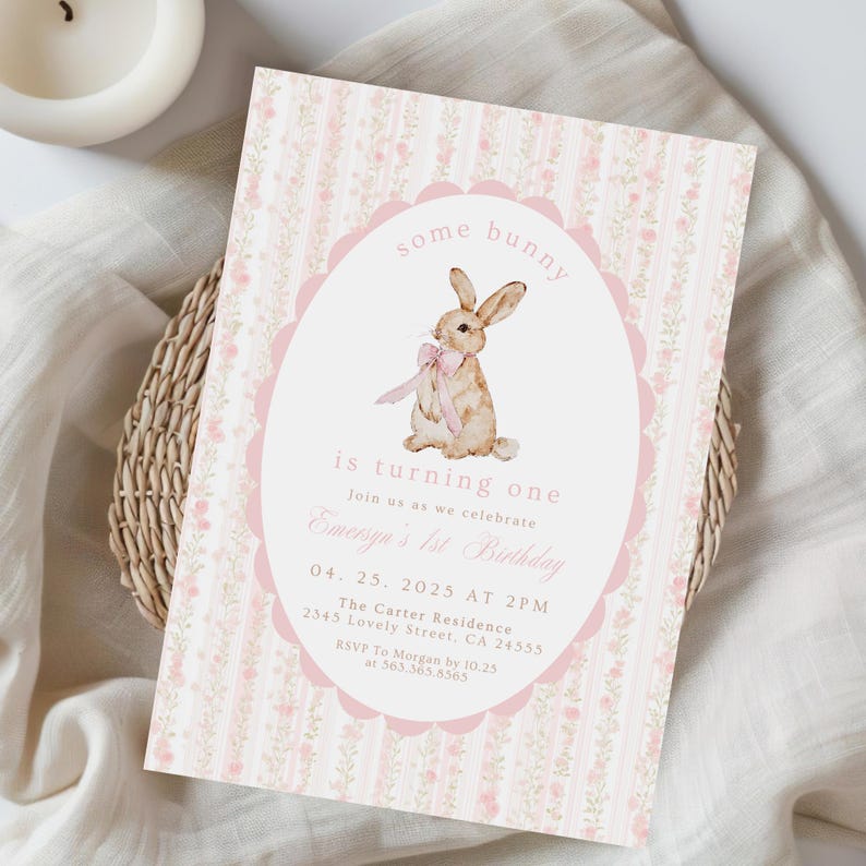 May include: A pink and white birthday invitation with a bunny illustration. The text reads "some bunny is turning one" and includes event details. The invitation has a floral pattern and scalloped edges.