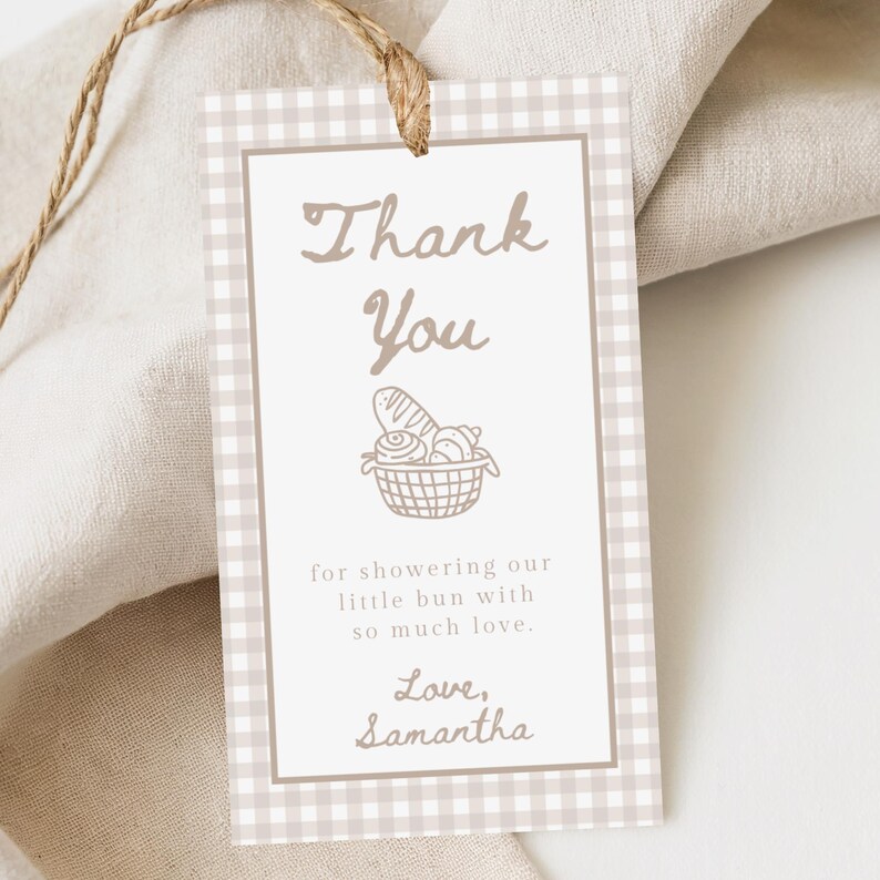 May include: A beige and white gingham tag with the words "Thank You" in a script font. Below is a basket of bread and the text "for showering our little bun with so much love. Love, Samantha."