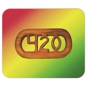 May include: Wooden 420 design on a mouse mat. The wooden design is in the shape of an oval with the numbers 420 carved out. The background is a gradient of red, yellow, and green.