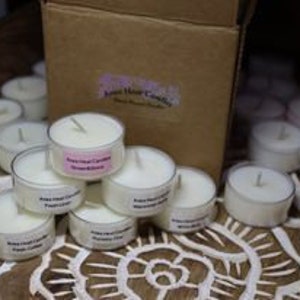 May include: A box of 20 unscented tea light candles. The candles are white and are arranged in a pyramid shape. The box is brown with a white label that says "Pure Love Candles".
