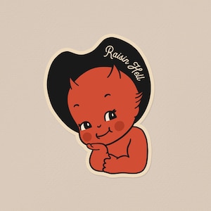 May include: A sticker depicting a cartoon devil baby with red skin, small horns, and a black hat. The text "Raisin Hell" is written in a cursive font on the hat. The baby is smiling and has its chin resting on its hand.