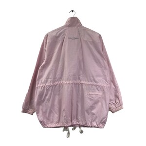 May include: A pale pink Courr&egrave;ges Paris jacket, hanging against a white backdrop. The jacket features a high collar, long sleeves, and a drawstring waist. The Courr&egrave;ges Paris logo is printed on the upper back. The jacket is made of a lightweight material.