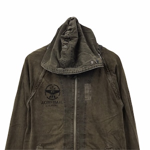 May include: Olive green hooded jacket with a full-length zipper. The jacket features a black graphic on the chest that reads "AERO MAIL U.S. ARMY". The hood has a button closure and the jacket has a military-inspired design.