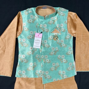 May include: A light green and gold waistcoat with a floral pattern and a pocket square. The waistcoat is part of a two-piece outfit, which also includes a pair of matching pants.