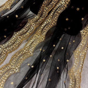 May include: Black sheer fabric with a gold embroidered border. The border features a scalloped design with floral motifs.