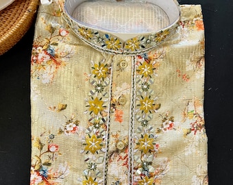 May include: A beige kurta with a floral print and embellished trim. The trim features small, mirrored flowers and beads.