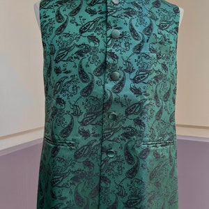May include: A green paisley patterned vest with black buttons.