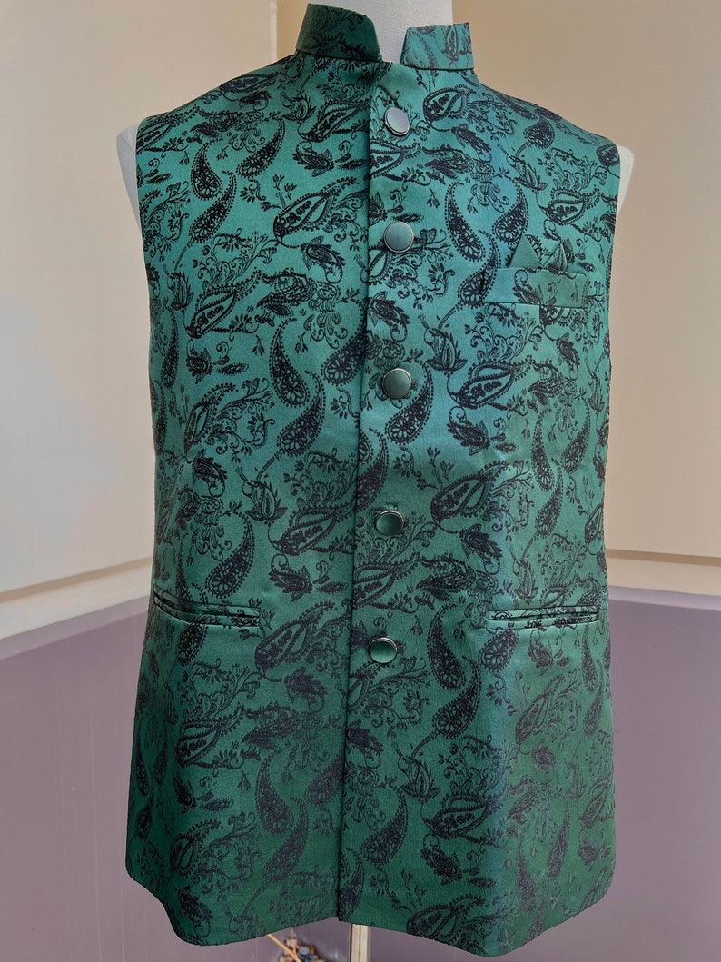May include: A green paisley patterned vest with black buttons.