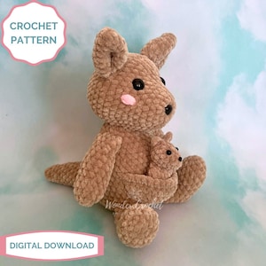 May include: A crocheted brown kangaroo holding a smaller crocheted brown joey in its pouch. The kangaroo has black eyes and pink cheeks. The crochet pattern is available as a digital download.